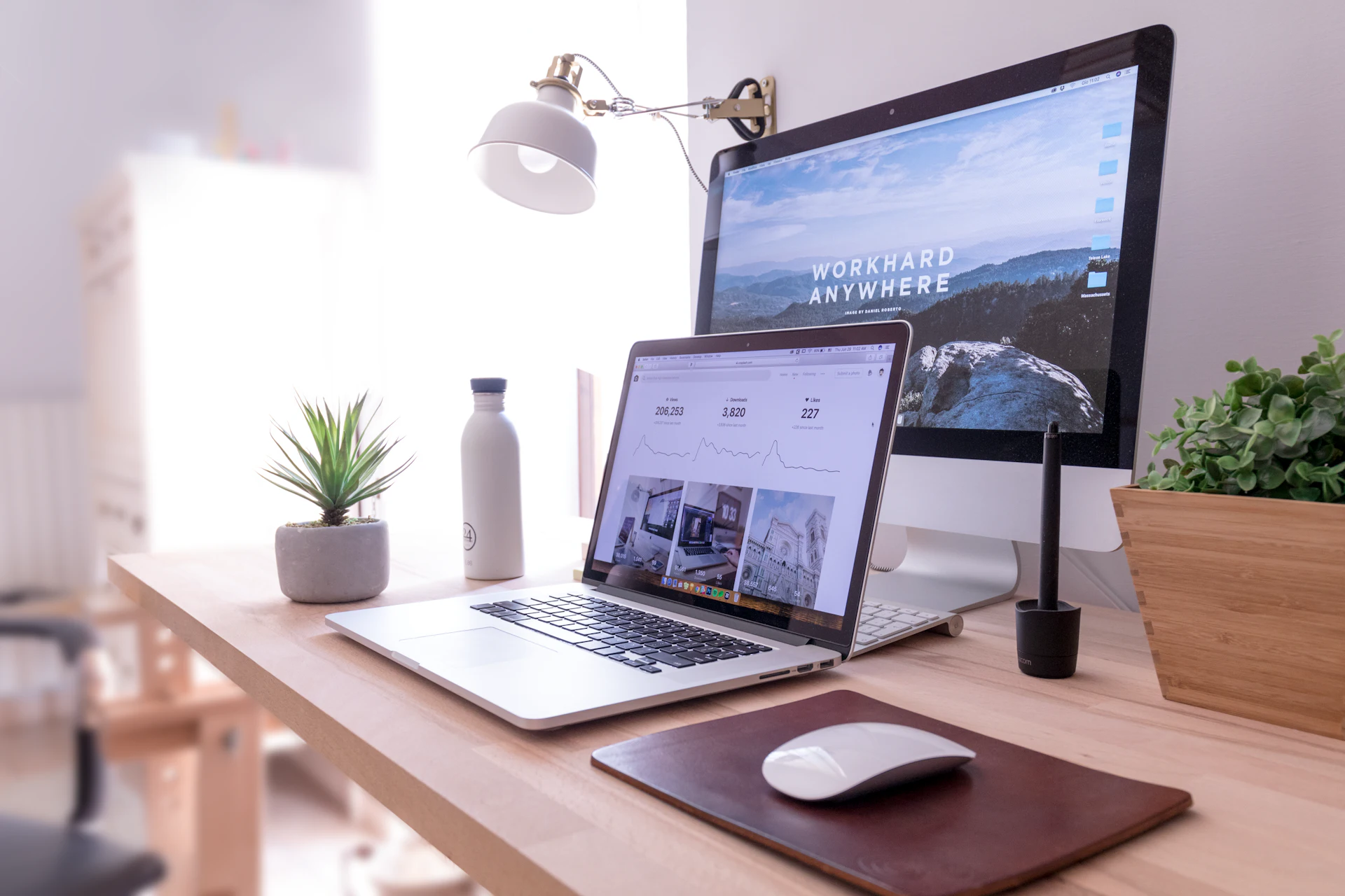 Website design workspace with desktop monitor and laptop