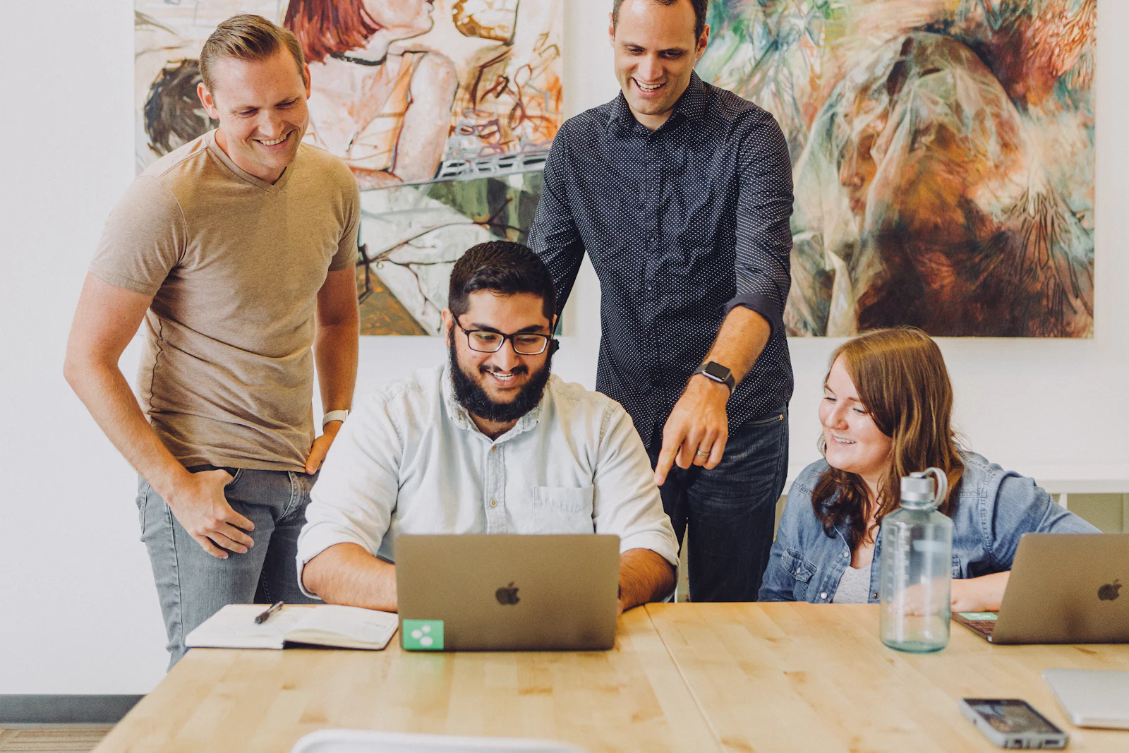 Marketing team working together on a laptop