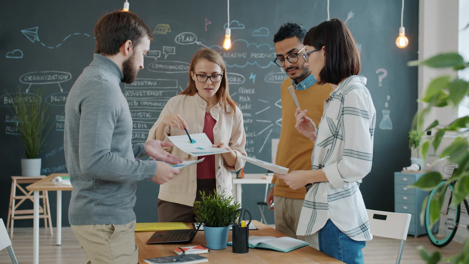 Team planning a digital marketing mission at a chalkboard