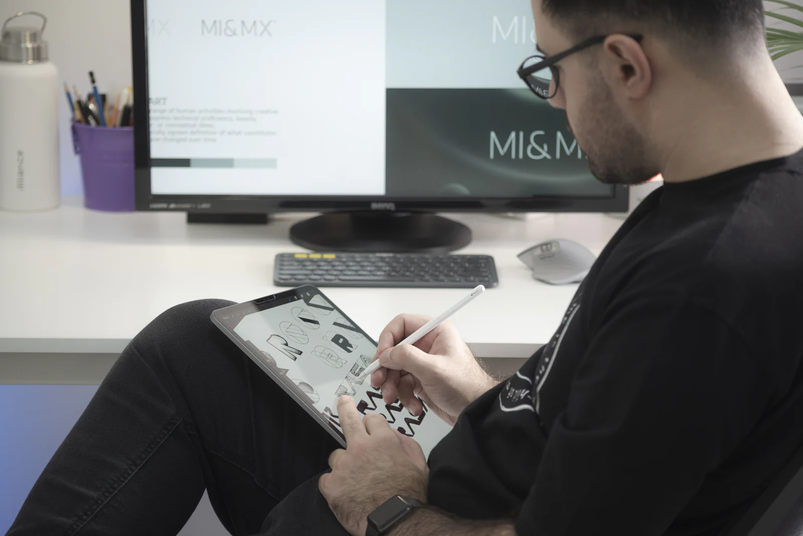 Graphic designer sketching a logo on a pen display