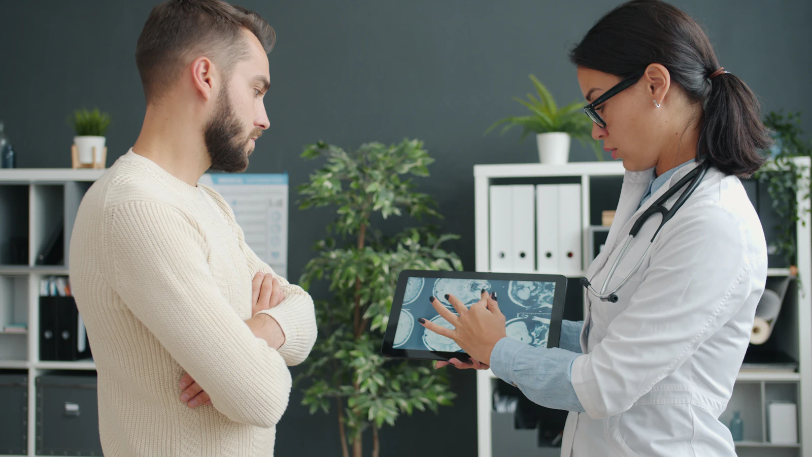 Practitioner reviewing results with a patient on a tablet