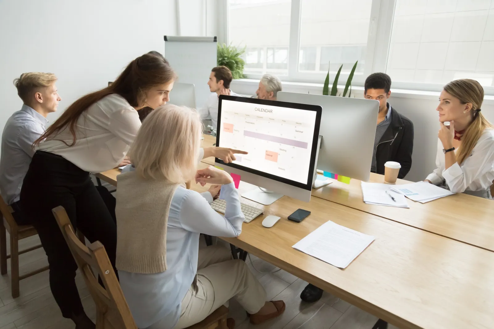 Team planning a new website together around a computer